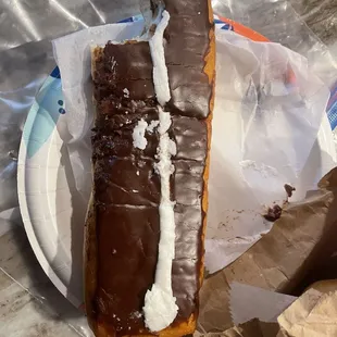 a half eaten donut on a paper plate