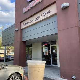 a hand holding a cup of coffee