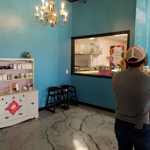 Some of their coffee on the white cabinet and also a window into their bakery. So you can see how they make their donuts.