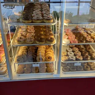 a variety of donuts in a display case