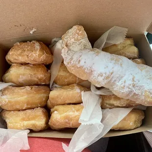 Yeast donuts, lemon filled donuts, and a creme horn.