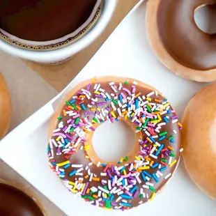 a variety of donuts and a cup of coffee