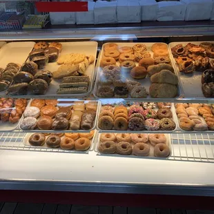 a variety of donuts in a display case