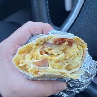 Breakfast burrito, eggs, ham, bacon and cheese