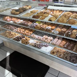 a variety of donuts in a display case