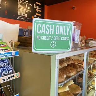 a cash only sign in a bakery