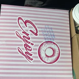 a box of doughnuts and a cup of coffee