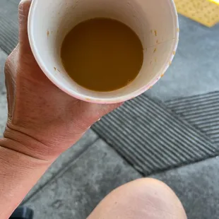 a person holding a cup of coffee
