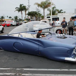 Lowers to the ground and the top opens.