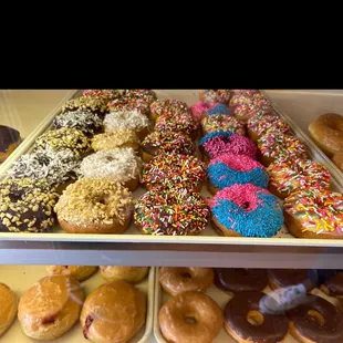 a variety of donuts in a display case