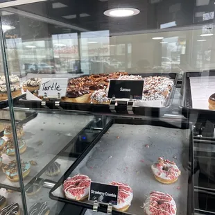 a variety of donuts in a display case