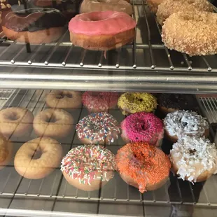 a variety of donuts in a display case