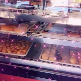 a variety of donuts in a display case