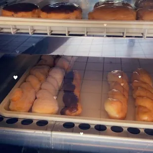 a variety of donuts in a display case