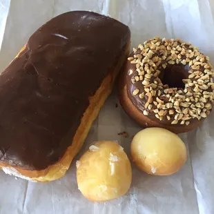 a chocolate frosted donut and two donuts
