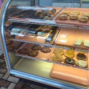 a variety of donuts in a display case