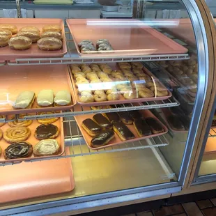 a variety of donuts in a display case