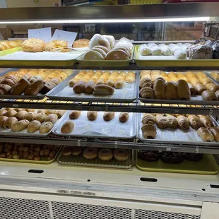 a variety of donuts in a display case