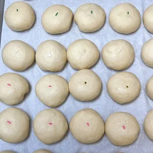 a tray of doughnuts with sprinkles