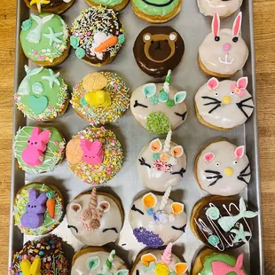 a tray of decorated donuts