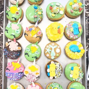 a tray of decorated donuts