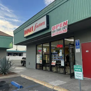 a donut factory located in a parking lot