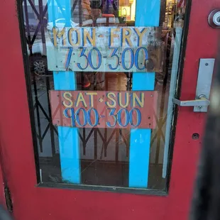 Front door with posted hours.