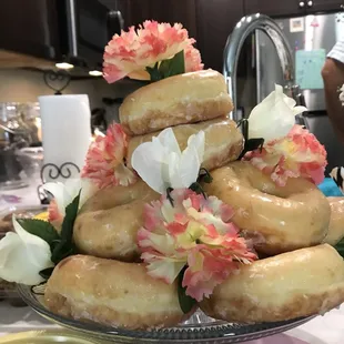 a stack of donuts with flowers on top