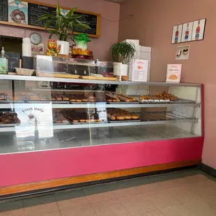 a display case with a variety of donuts