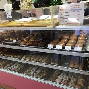 a variety of donuts in a display case