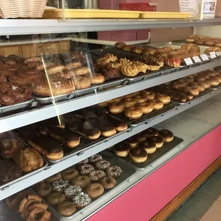 a variety of donuts in a display case