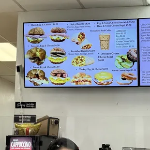 a woman sitting at a counter in front of a menu