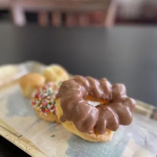 Chocolate French Cruller, Chocolate with Rainbow Sprinkles Cake, and donut holes