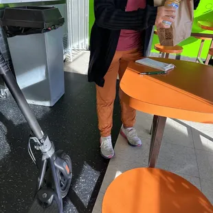 Owner gifting two doughnuts and an orange juice