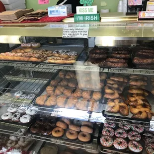 a variety of donuts in a display case