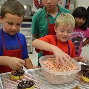 At the birthday party, the kids went WILD topping the fresh donuts with sprinkles!