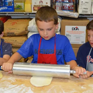 Little donut chefs in action at a birthday party!