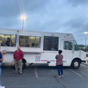 people standing in front of a food truck