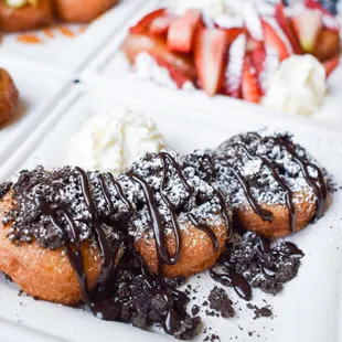 Ore-Uh-Oh:
Three made to order donuts topped with gluten free Oreos, powdered sugar, Chocolate sauce, served with a side of whipped cream