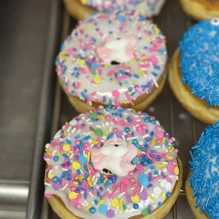 a row of donuts with frosting and sprinkles