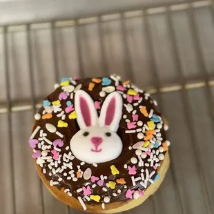 a chocolate frosted donut with a bunny face