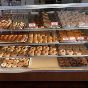 a variety of donuts in a display case