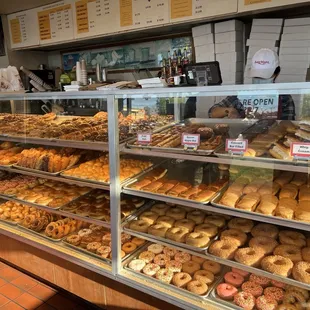 a variety of donuts in a display case