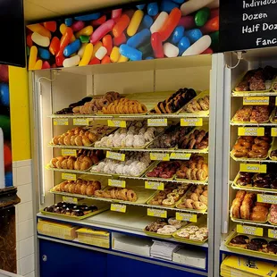 a variety of donuts in a display case