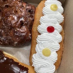 Cassata long john with vanilla cream stick and apple fritter poking in