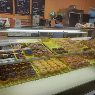 a variety of donuts in a display case
