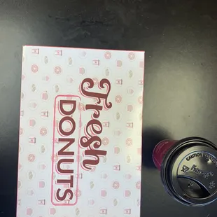 a box of donuts and a cup of coffee