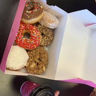 a box of doughnuts and a cup of coffee