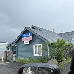 a blue building with a sign for donut mill