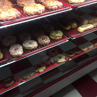 a variety of donuts in a display case